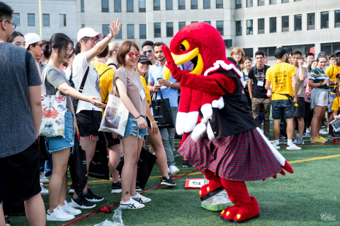 a group of students dancing with Marty, the 六合彩开奖结果 mascot